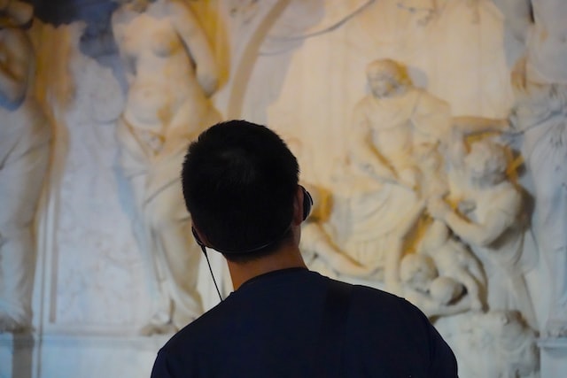 Person listening to an audioguide in an art museum